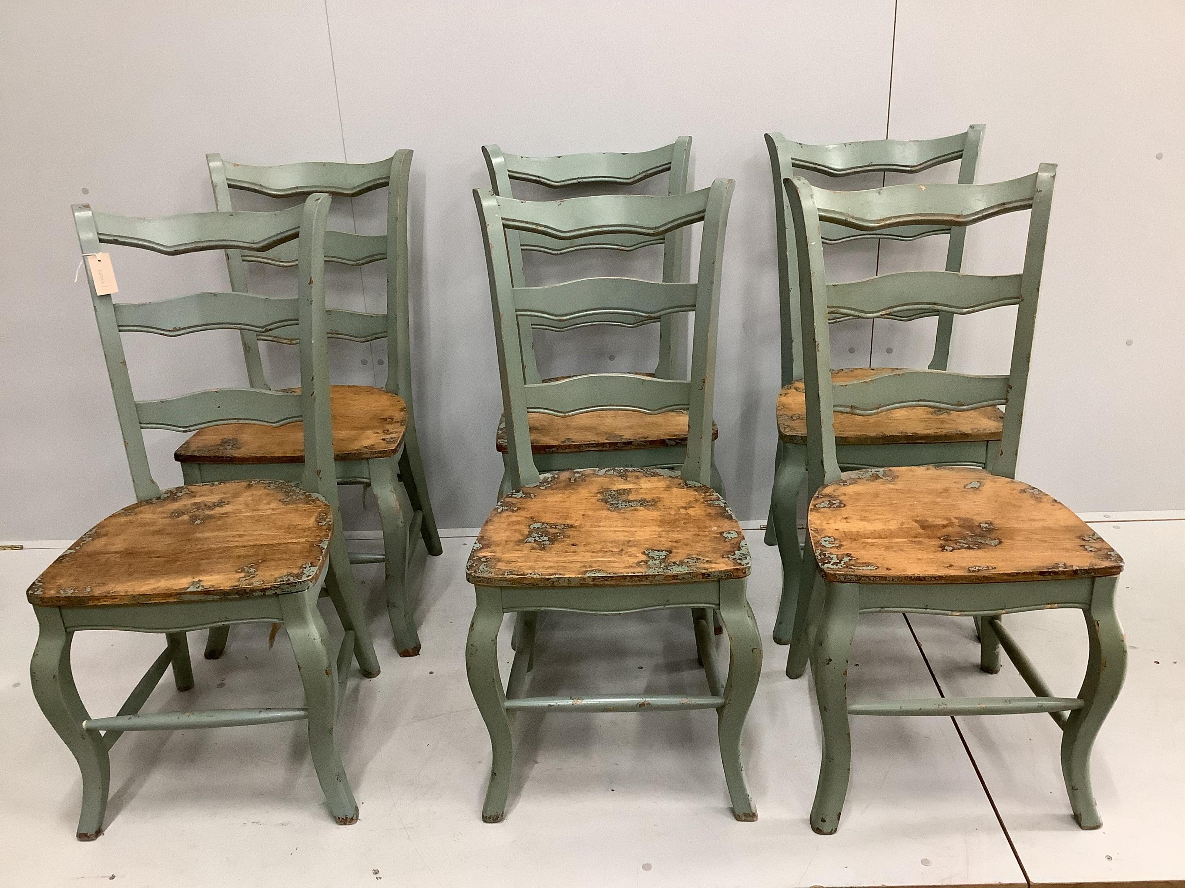 A French Provincial style part painted oak dining table, width 178cm, depth 87cm, height 77cm, together with six ladderback chairs. Condition - table good, chairs - good